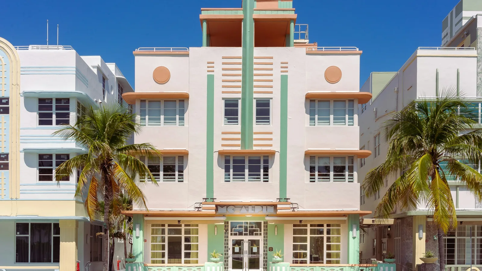 Pastel Art Deco building with rows of windows in Miami Beach