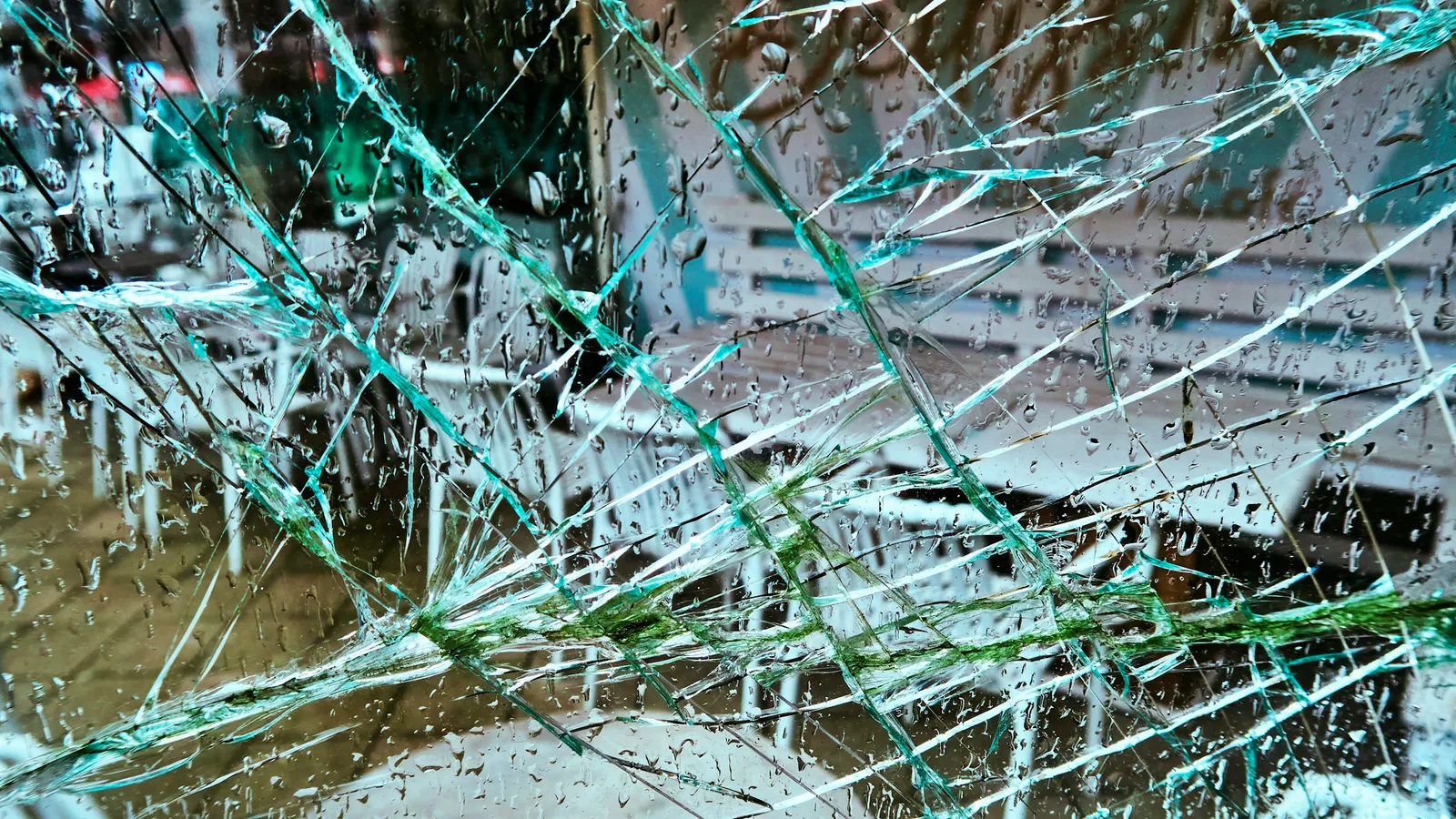 Close view of fractured glass with a radiating crack pattern